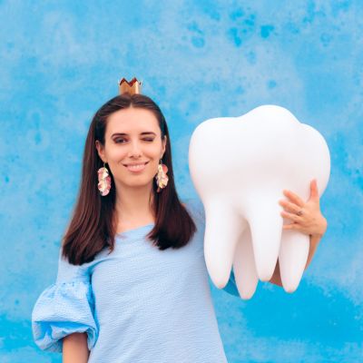 Woman holding a tooth model