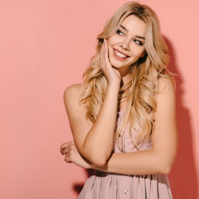 Woman smiling in pink background