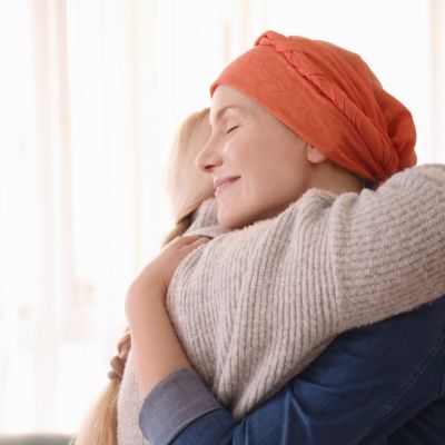 patient with cancer hugging her mother